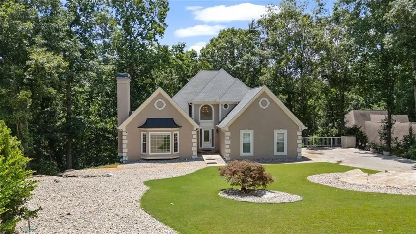 Stucco exterior with prominent chimney and bay window