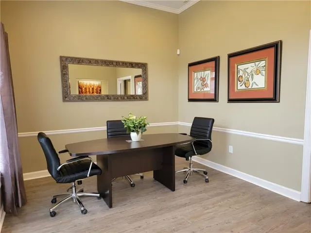 Neutral wall tones with white crown molding and chair rail accents