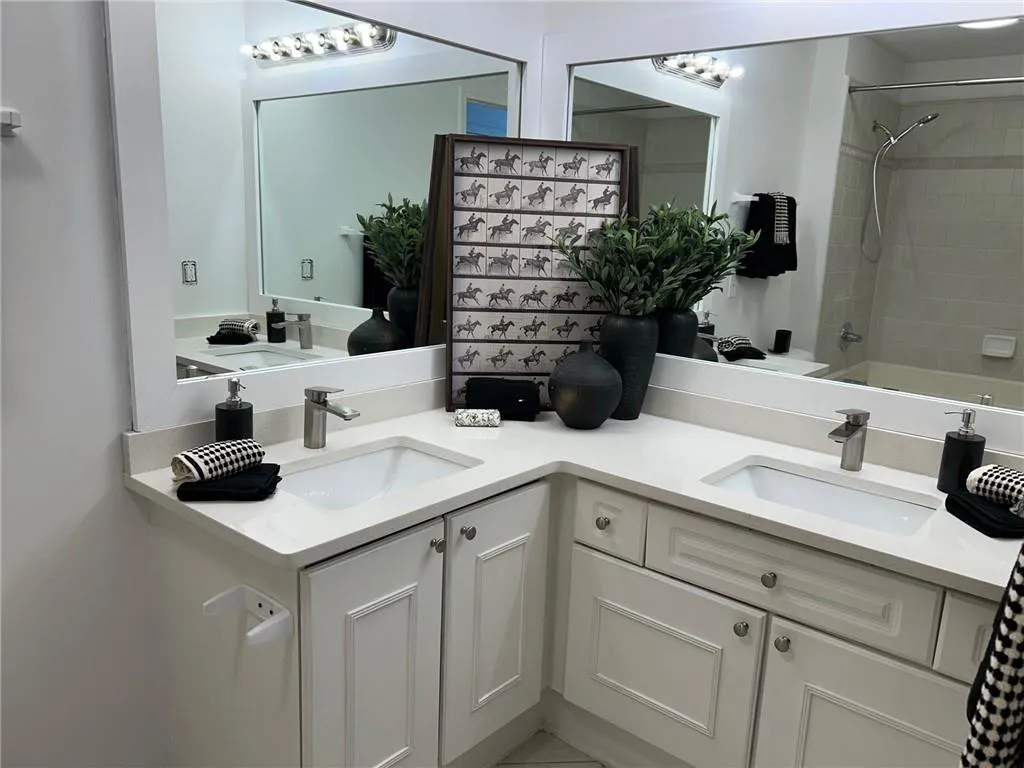 Dual vanity with white cabinetry and integrated sinks