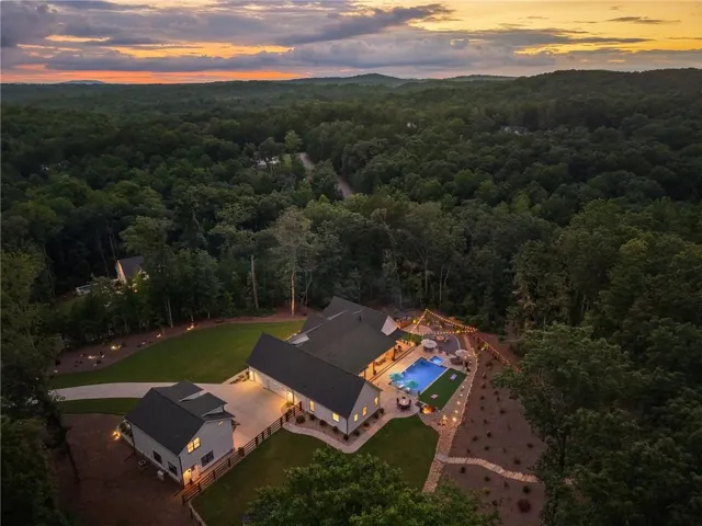 Expansive property with a large residence, separate detached structure, and a private pool area