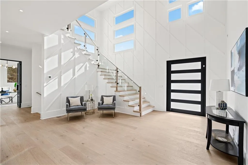 Foyer with a towering ceiling and light hardwood / wood-style flooring Foyer with a towering ceiling and light hardwood / wood-style flooring