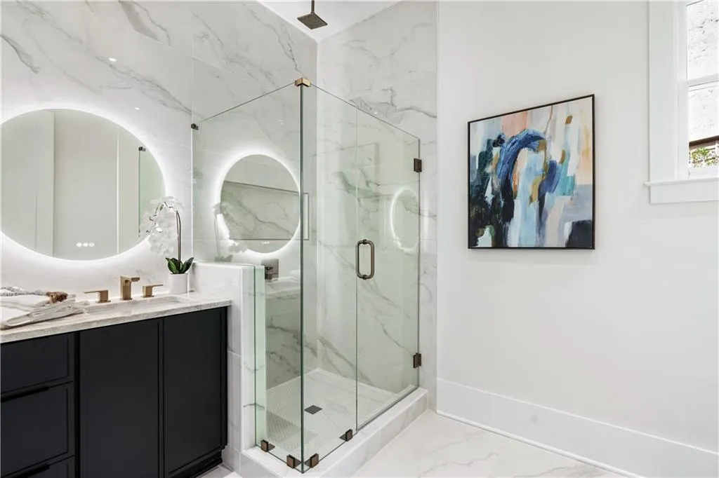 Bathroom featuring vanity and a shower with shower door Bathroom featuring vanity and a shower with shower door