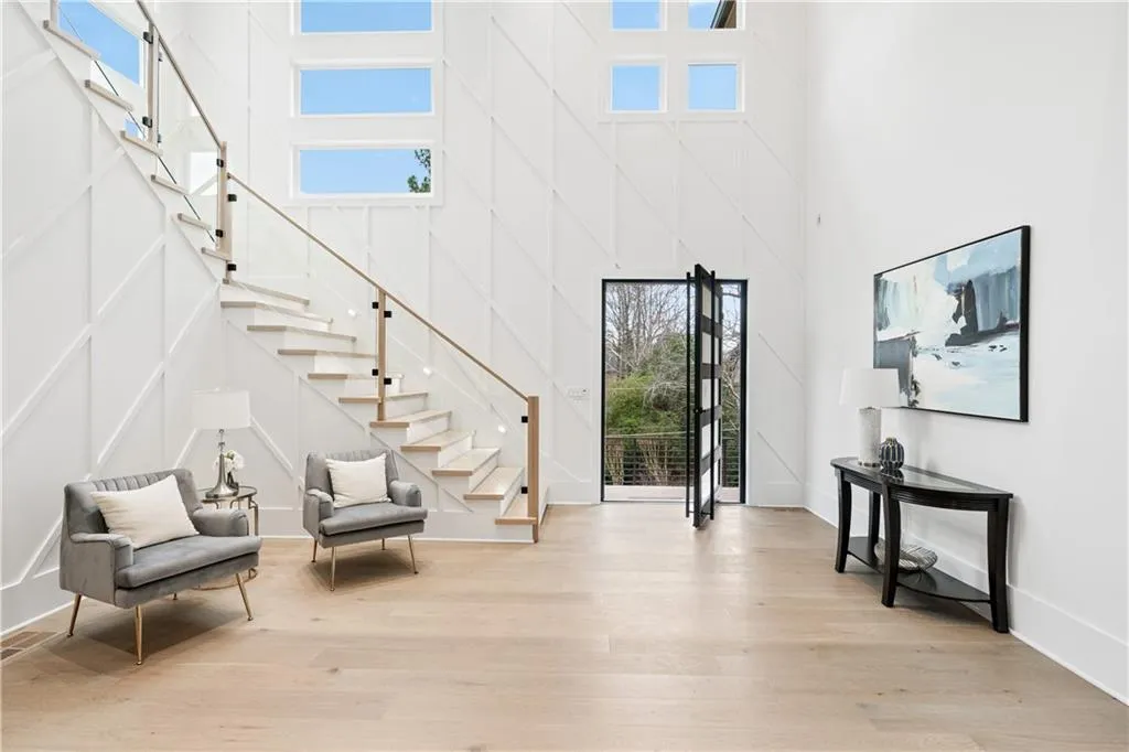 Entryway featuring a high ceiling and light hardwood / wood-style floors Entryway featuring a high ceiling and light hardwood / wood-style floors