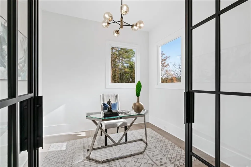 Home office featuring hardwood / wood-style flooring and an inviting chandelier Home office featuring hardwood / wood-style flooring and an inviting chandelier