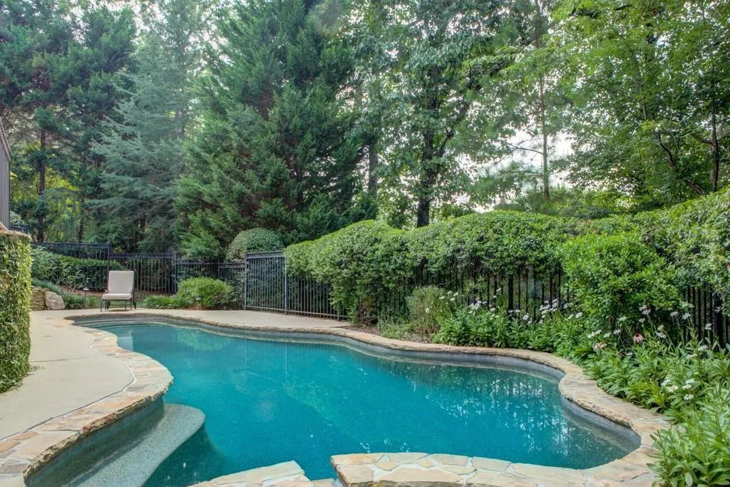 Covered outdoor living overlooking private pool, spa, and koi pond, with convenient access to 2nd kitchen - for easy entertaining