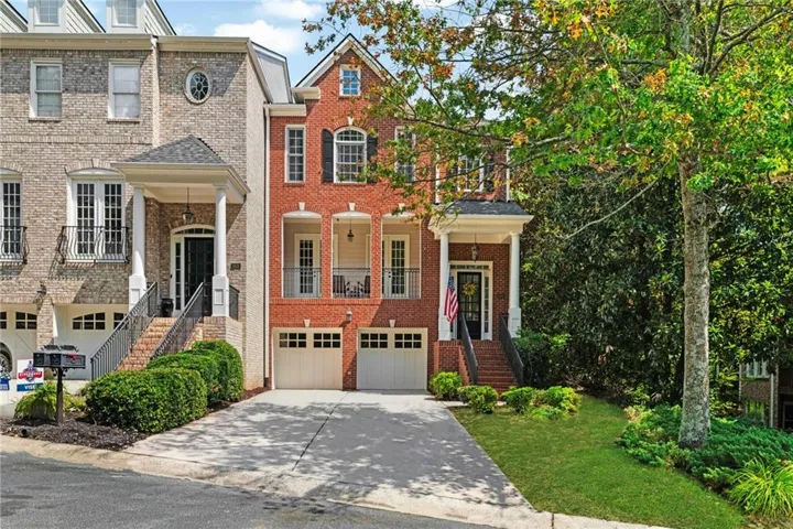 Red brick exterior featuring white trim and black shutters