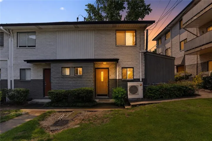 Brick and siding exterior with mature landscaping