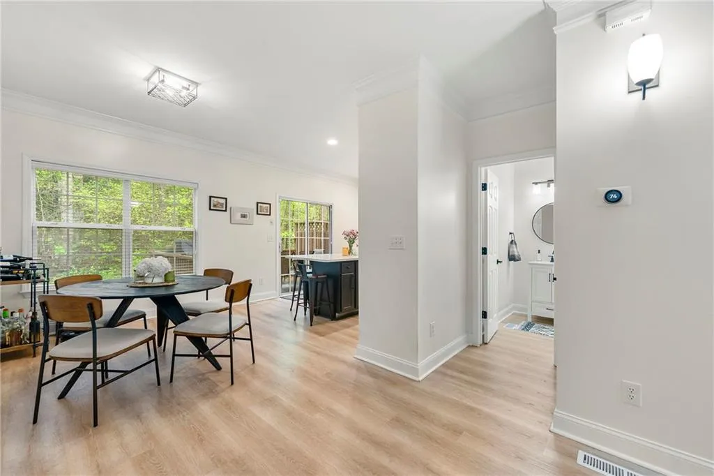 Dining space featuring crown molding, plenty of natural light, and light wood-type flooring