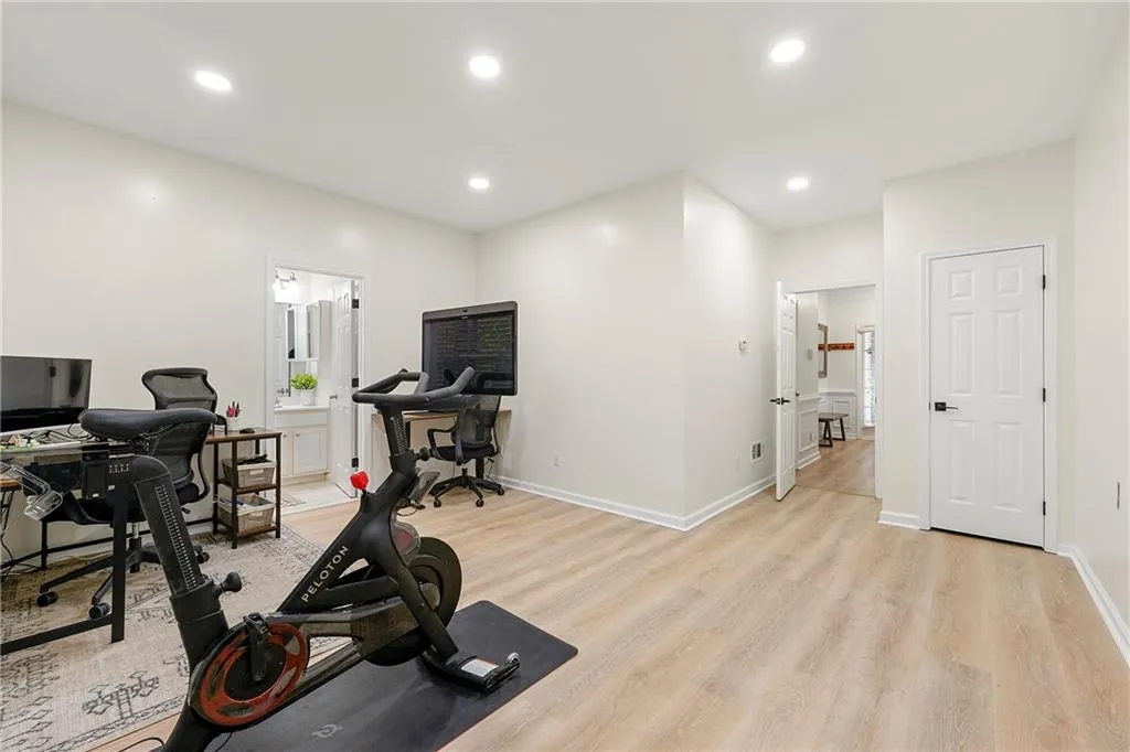 Workout room with light hardwood / wood-style flooring