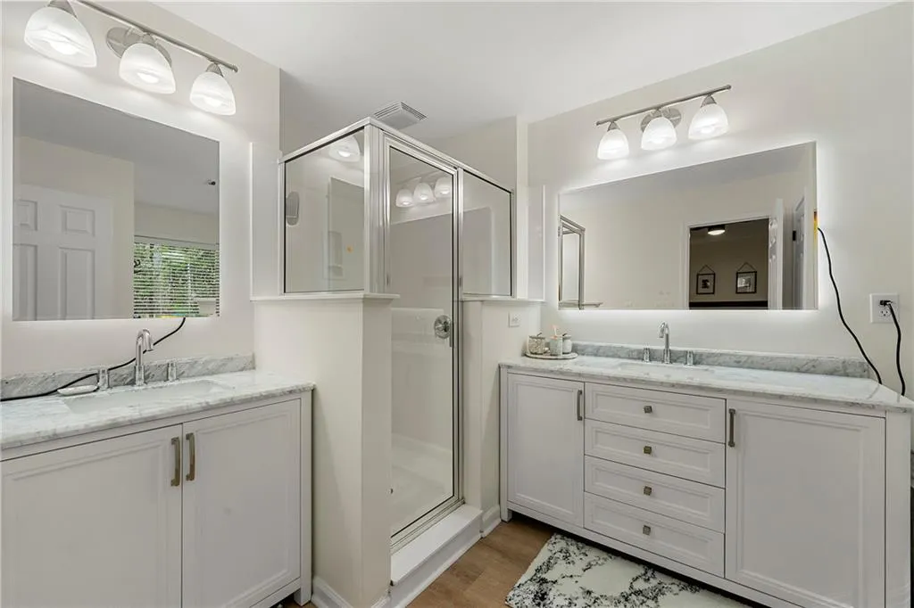 Bathroom featuring vanity, an enclosed shower, and hardwood / wood-style flooring