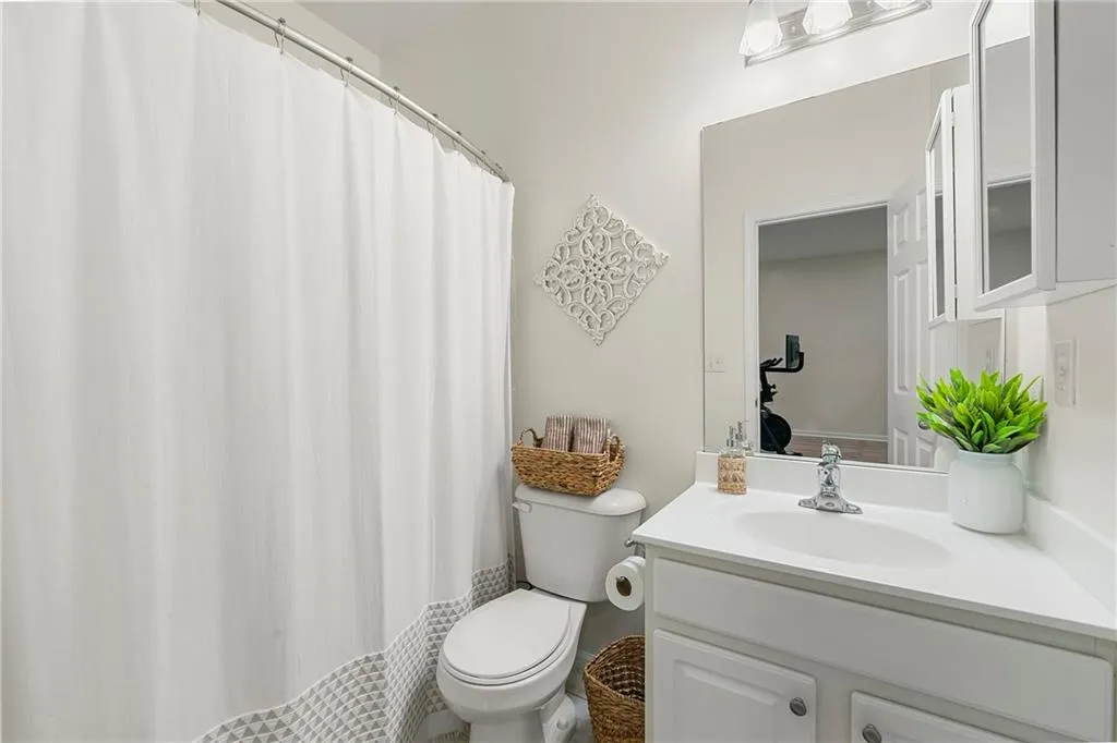 Bathroom featuring large vanity and toilet
