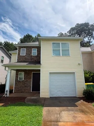 Two-story exterior featuring stone veneer and horizontal siding