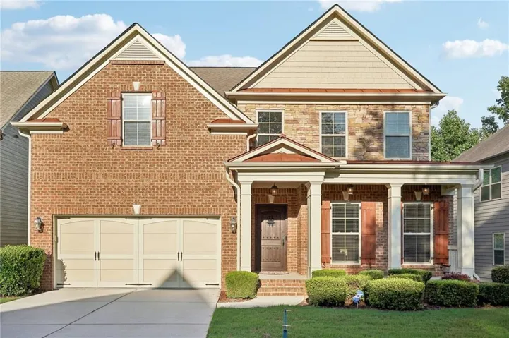 View of front of house with a garage and a front lawn