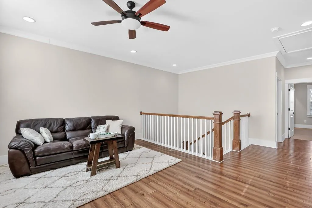 Living area featuring crown molding, light wood finished floors, recessed lighting, and ceiling fan