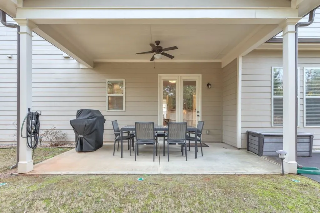 View of patio / terrace with a ceiling fan, outdoor dining space, and area for grilling