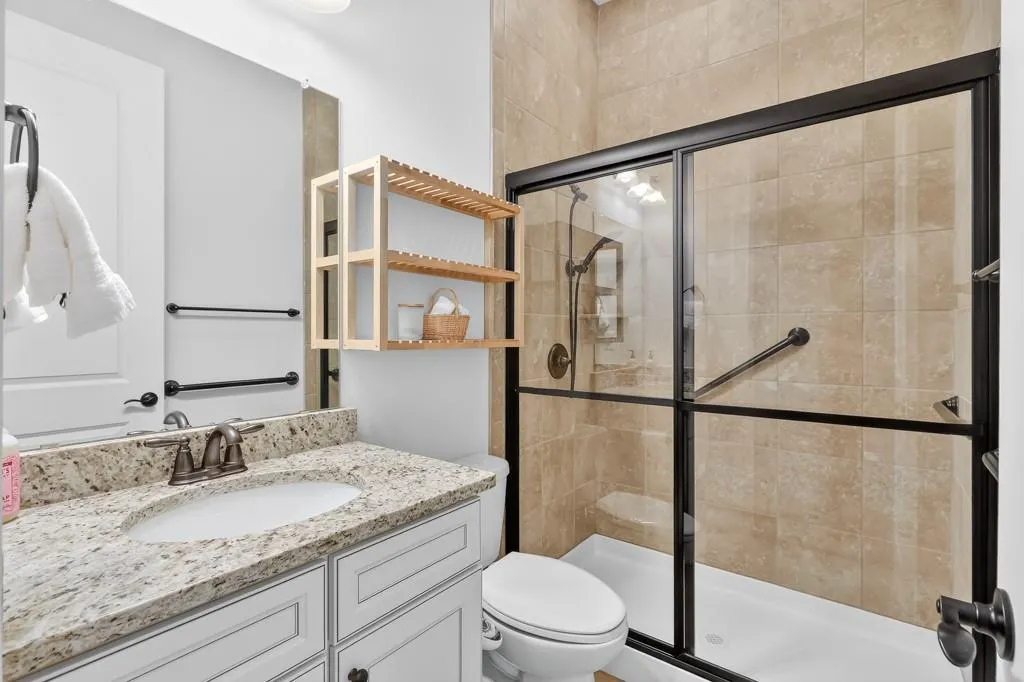 Bathroom with a shower stall and vanity