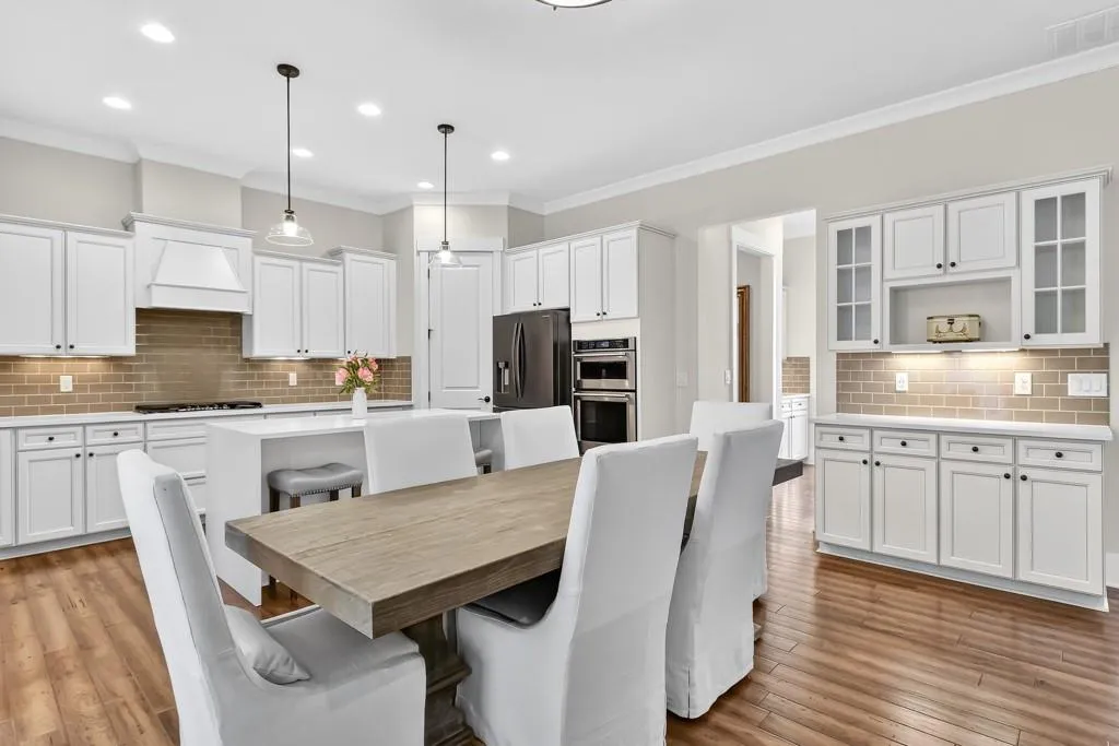 Dining area featuring ornamental molding, light wood-type flooring, and recessed lighting