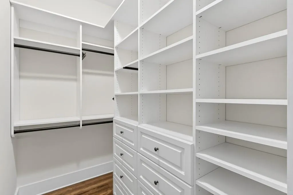 Walk in closet featuring dark wood-style flooring