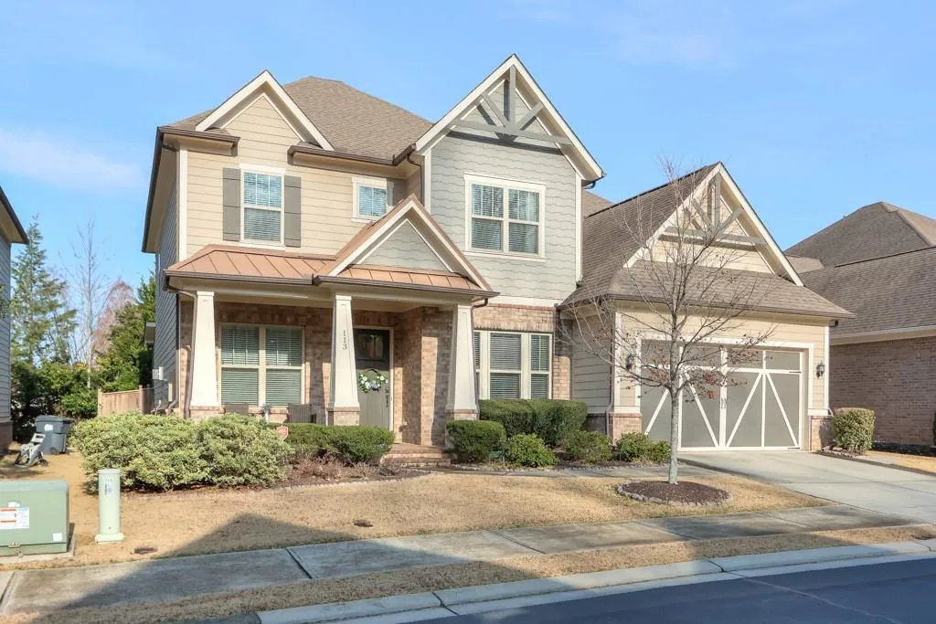 Craftsman house featuring covered porch, brick siding, concrete driveway, roof with shingles, and a standing seam roof