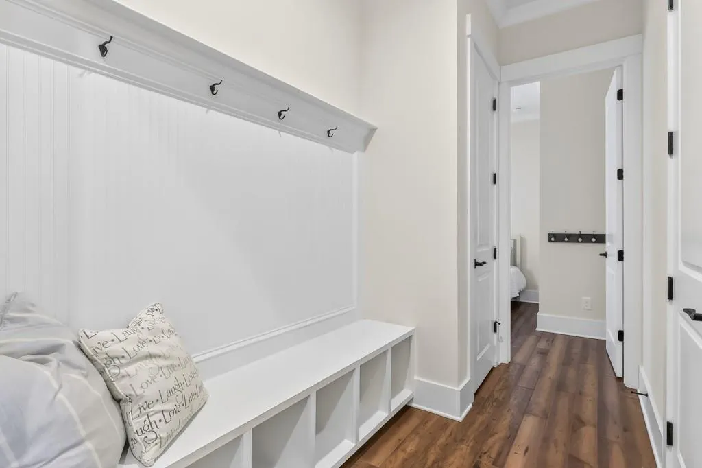 Mudroom featuring dark wood-type flooring and baseboards