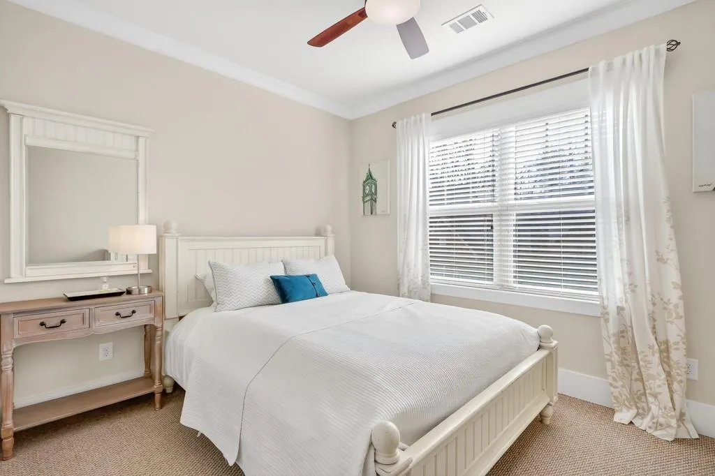 Bedroom featuring carpet floors, ceiling fan, and crown molding