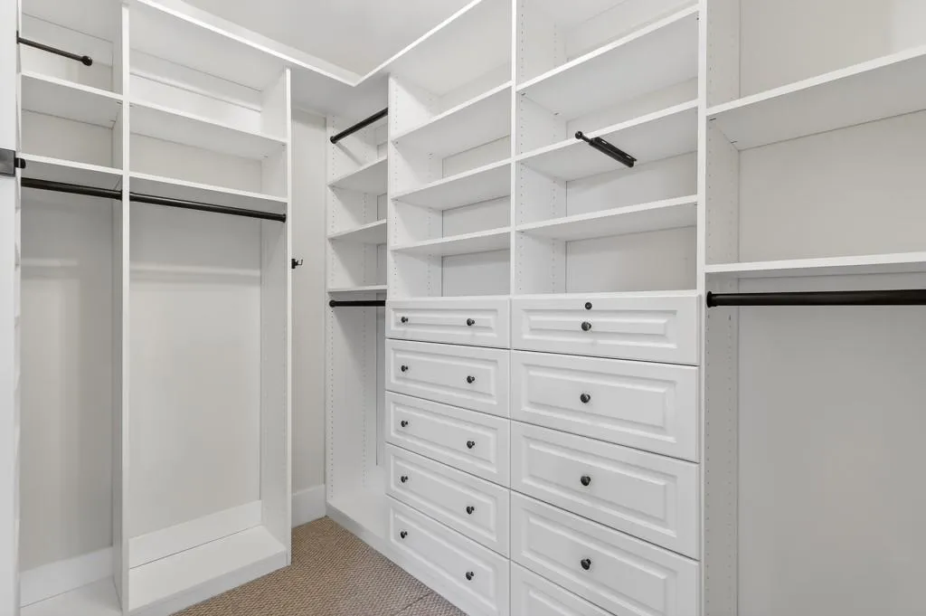 Walk in closet featuring light carpet