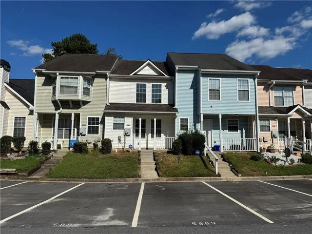 Front façade featuring siding exterior, bay window, covered porch, and asphalt shingle roof