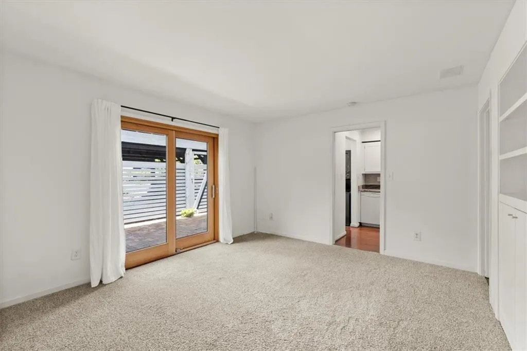 Bonus room/office with built in bookshelves featuring access to exterior front patio