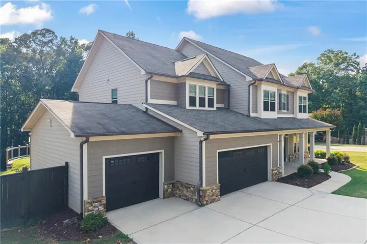 From its welcoming covered front porch to its expansive homesite, every detail of this home reflects thoughtful design and pride of ownership. Positioned on nearly an acre, the property offers the rare combination of privacy, outdoor space, and neighborhood convenience.
