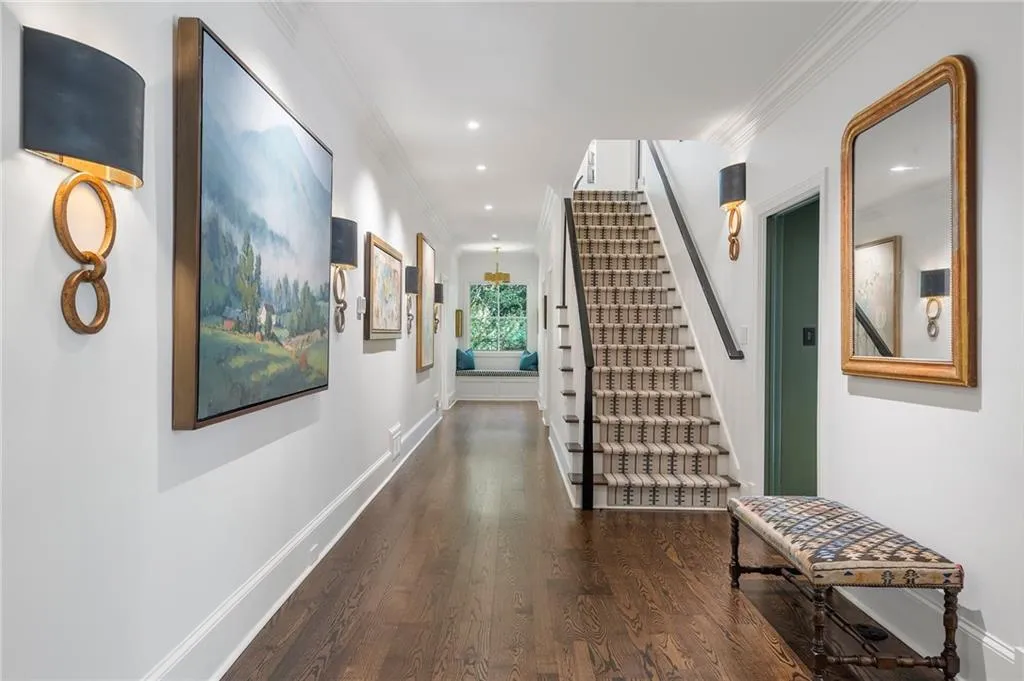 Wide main hallway has primary plus 2 on suite bedrooms.