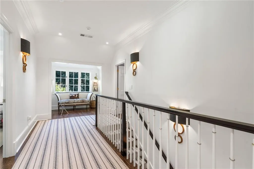 Stairwell up with wide hall to 2 guest bedrooms.