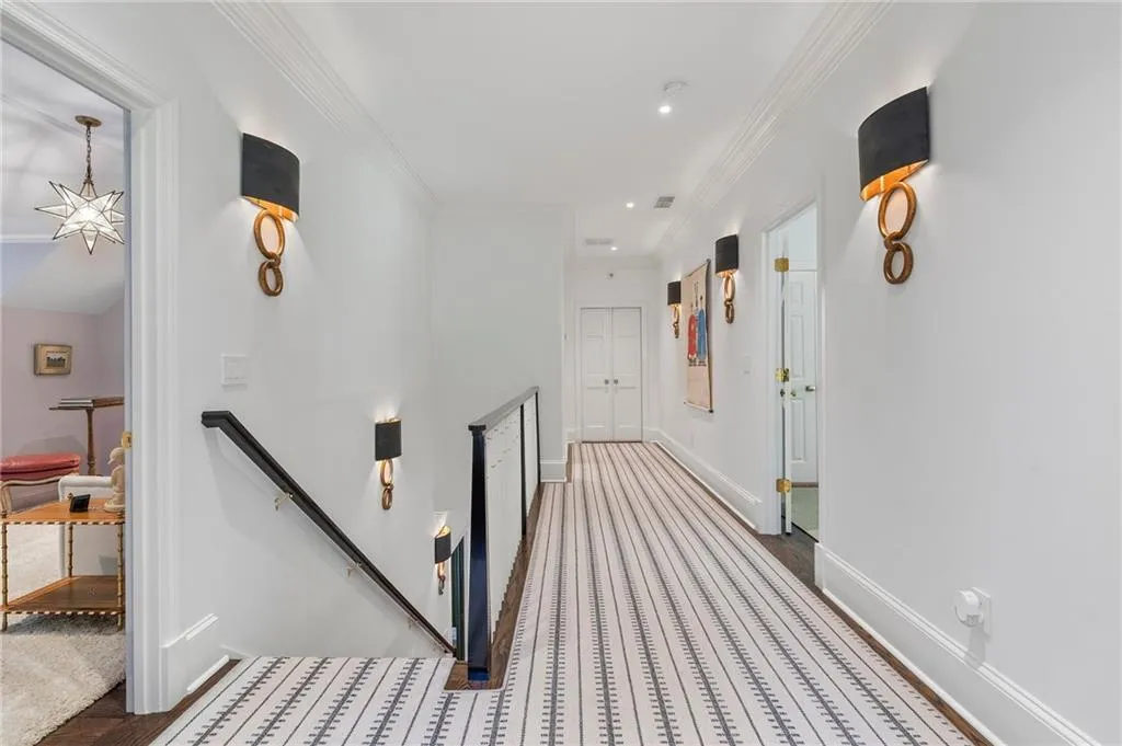 Stairwell with wide hall to 2 guest bedrooms.