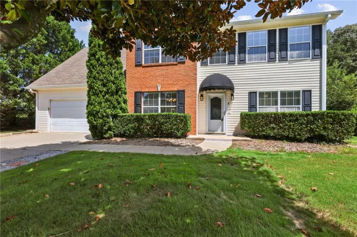 Two-story exterior featuring brick and siding finishes