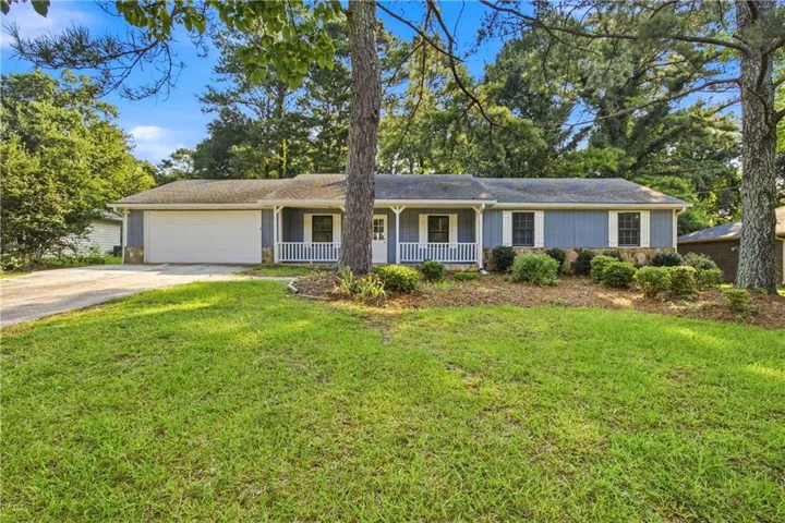 Ranch-style residence featuring blue siding, white trim, and a white front porch with railings