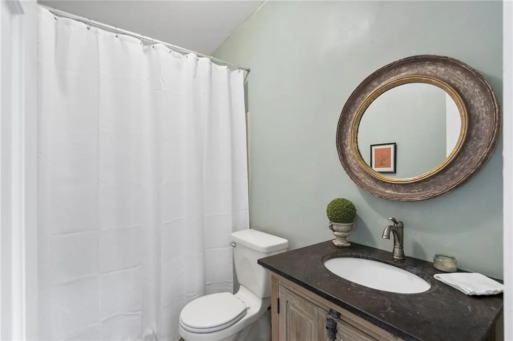 Bathroom with vanity and a shower with shower curtain
