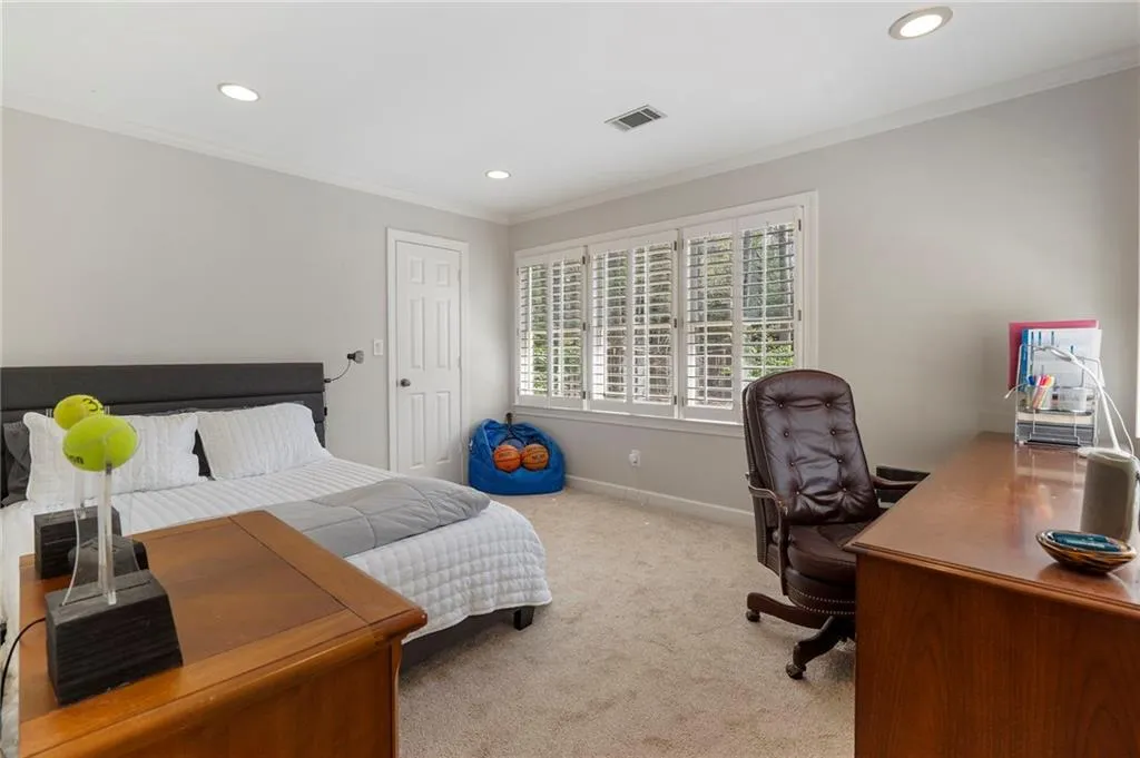 Carpeted bedroom featuring crown molding, a desk, and recessed lighting