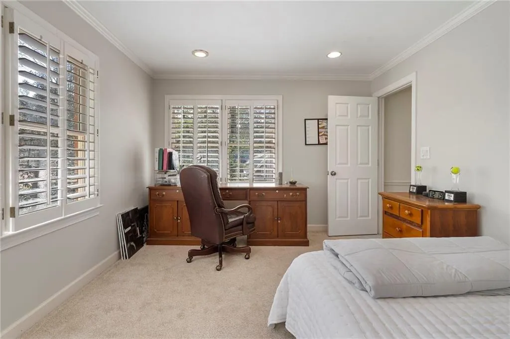 Bedroom with light carpet, crown molding, and recessed lighting