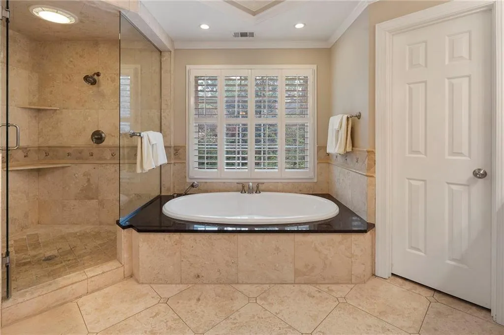 Full bathroom with ornamental molding, a stall shower, a garden tub, recessed lighting, and tile patterned flooring