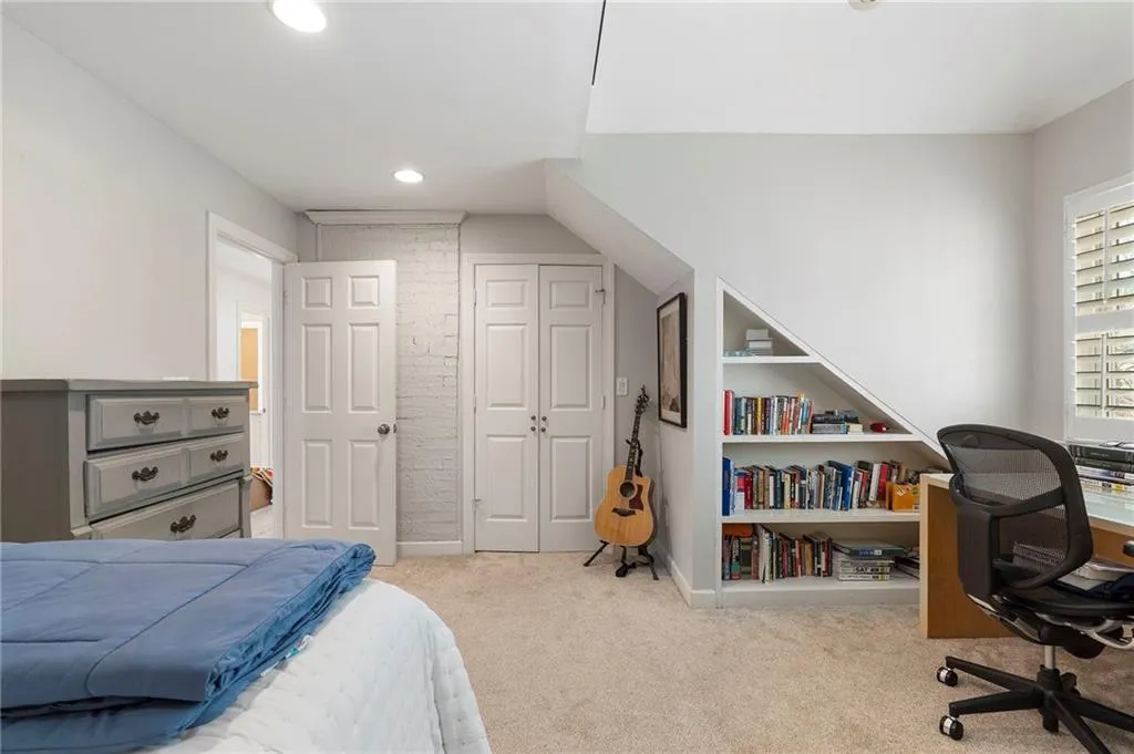 Bedroom with a desk, a closet, light colored carpet, and recessed lighting