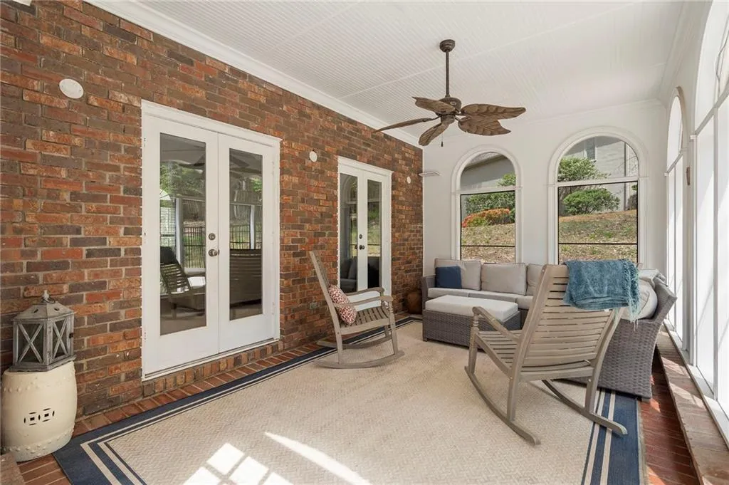 Sunroom featuring french doors, ceiling fan, and outdoor furniture