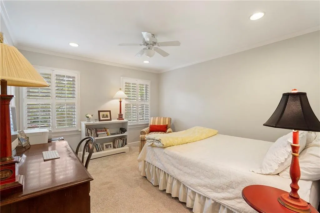 Bedroom with light carpet, crown molding, recessed lighting, and a ceiling fan