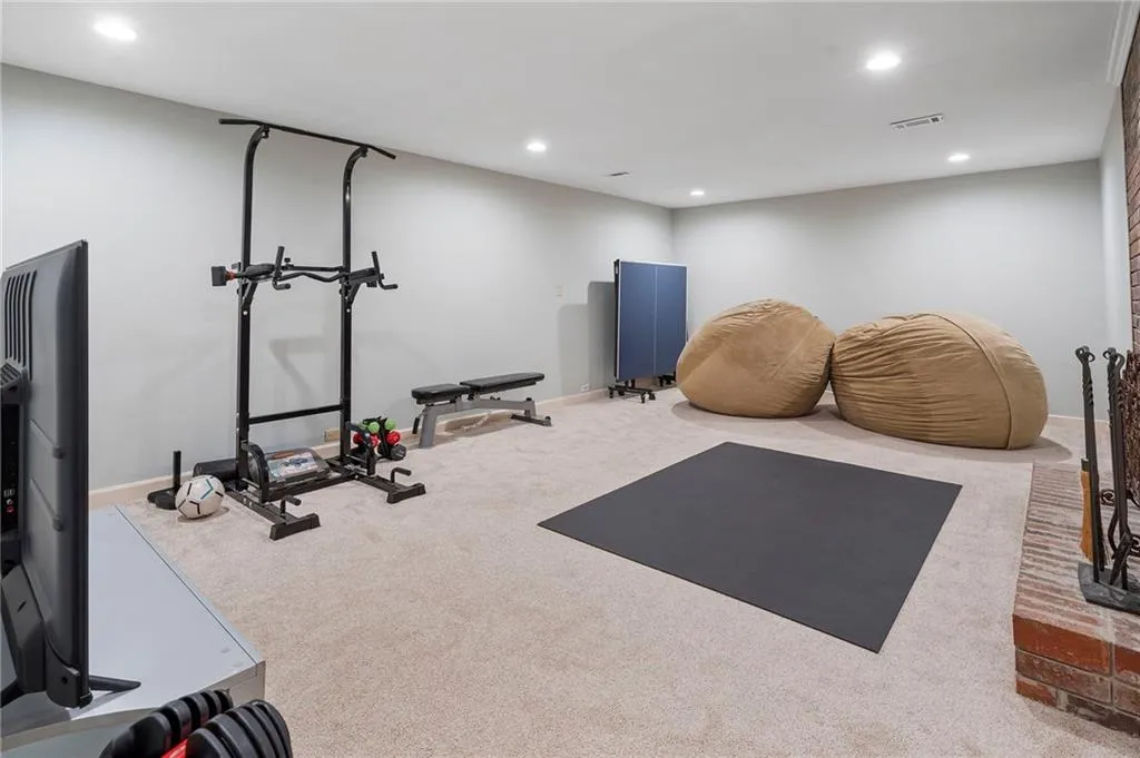 Exercise room with recessed lighting and carpet