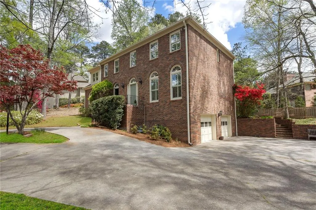View of front of home with asphalt driveway, brick siding, and a garage