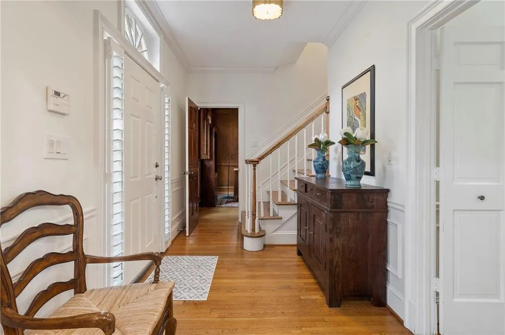 Foyer with ornamental molding and light wood-style flooring