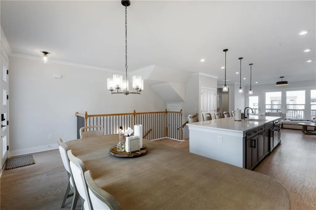 Dining area featuring ornamental molding, light wood-style flooring, recessed lighting, and a chandelier