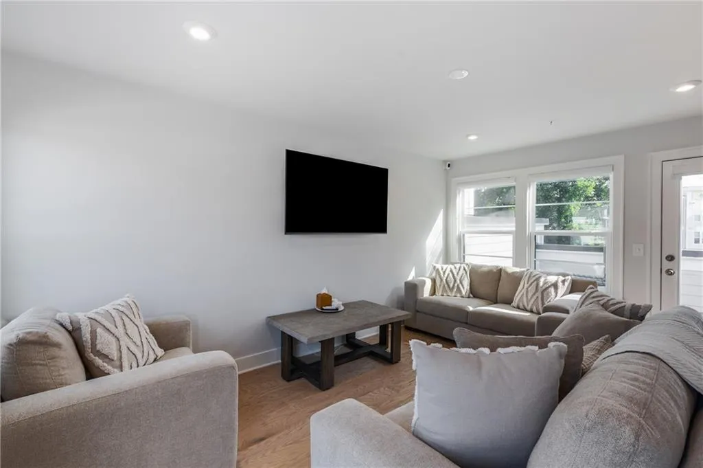 Living area with recessed lighting and wood finished floors
