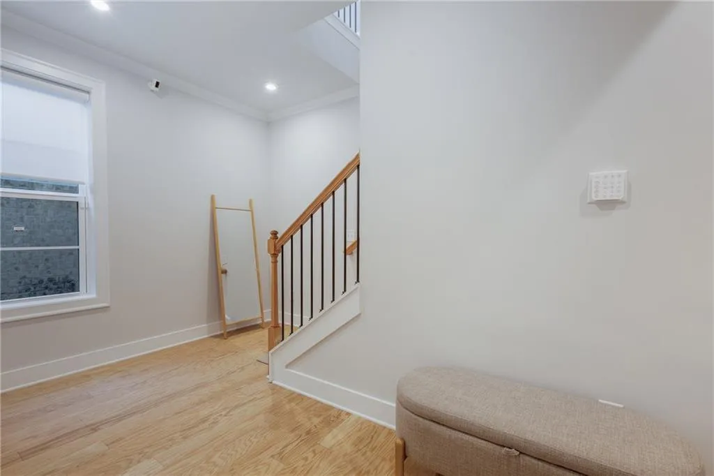 Stairs with wood finished floors and ornamental molding