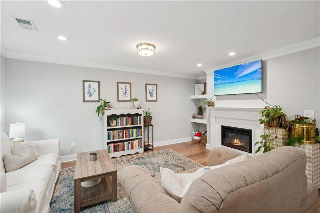 Living room featuring hardwood / wood-style flooring and ornamental molding