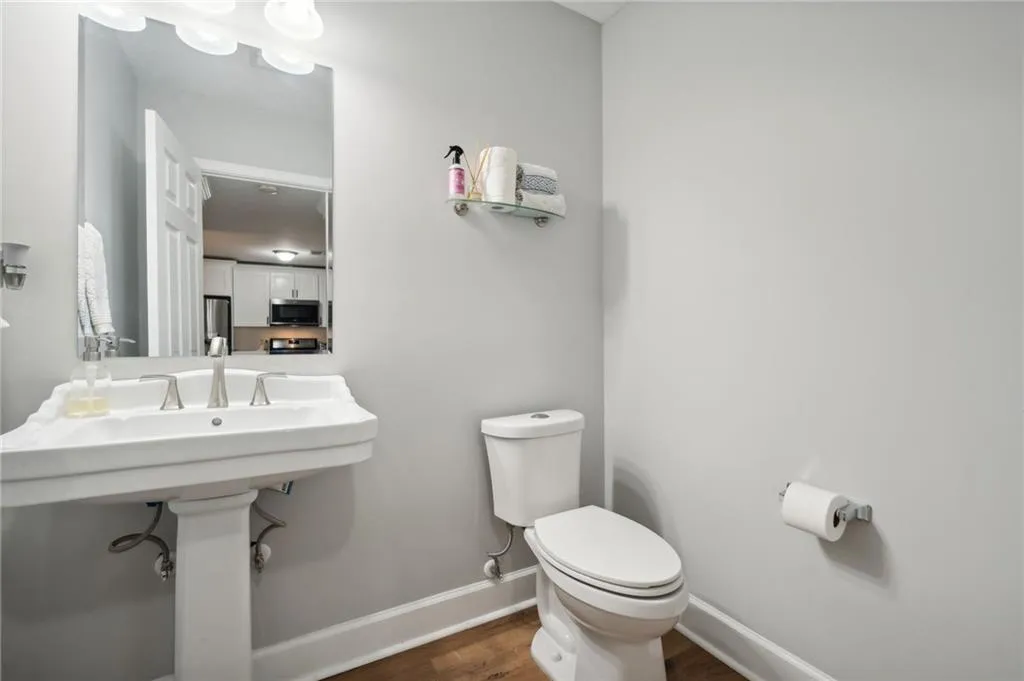 Bathroom with hardwood / wood-style floors and toilet