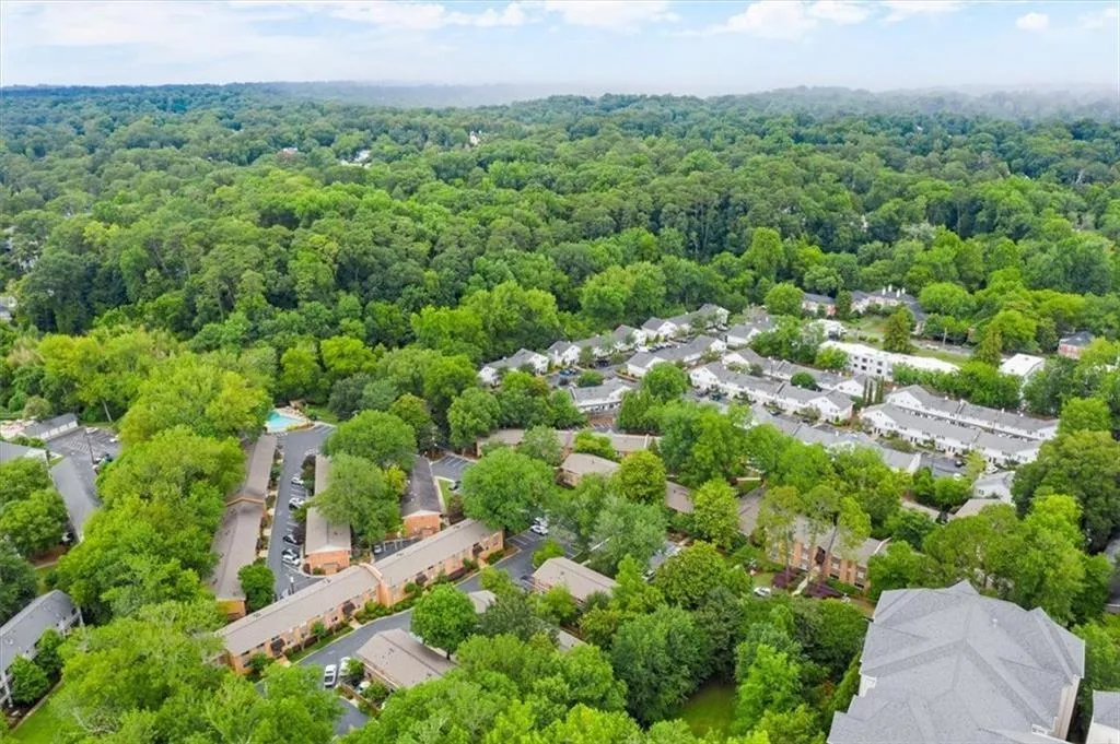 Aerial view of residential area featuring a forest